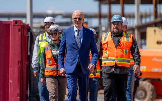 President Joe Biden and union members building Intel's Ocotillo Campus walk onstage before announcing $20 billion in investments to ramp up production of semiconductor chips in Arizona.
